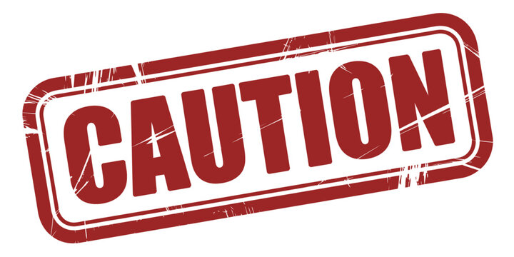 A red rubber stamp imprint that says "CAUTION" in white capital letters.