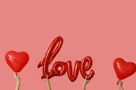 Women with word LOVE made of balloons on pink background. Valentine's Day celebration - Powered by Adobe