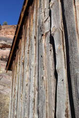 A macro image of barn superstructure with western terrain in the background
