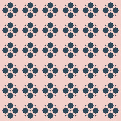 Chic seamless geometric pattern with small navy blue quatrefoil motifs clustered in repeating diamond grid layout on solid blush pink background. It has a modern Moroccan tile inspired feel. Vector