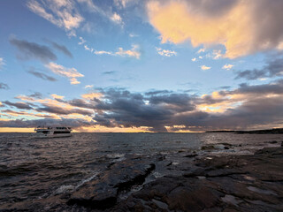 serene maritime scenery, quiet scene of small boat near coast at evening with pastel sky reflections