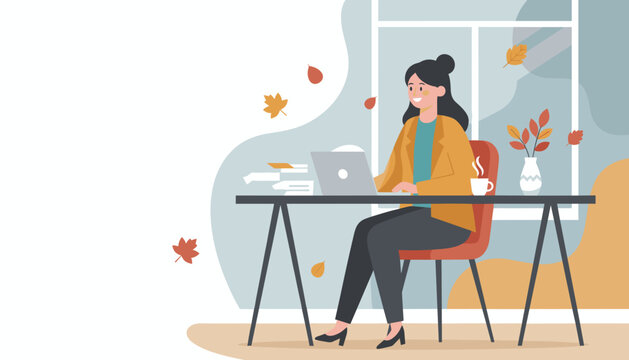 Woman works remotely on a laptop in a cozy autumn office enjoying coffee and productivity