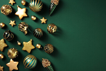 Elegant Christmas background with gold decorations, including baubles, stars, and pine cones. Flat lay, top view.