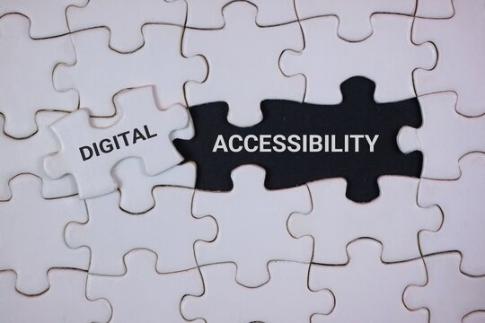 A close-up of interlocking puzzle pieces highlighting digital accessibility. The black piece labeled ACCESSIBILITY and a white piece labeled DIGITAL, symbolizing inclusive technology and design.
