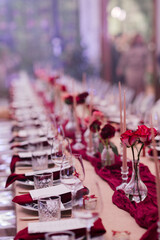 Coziness and style. Modern event design. Table setting at wedding reception. Floral compositions...