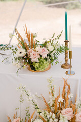 Coziness and style. Modern event design. Table setting at wedding reception. Floral compositions...