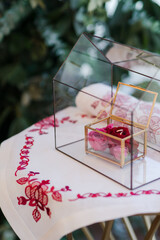 Modern wedding jewelry. Closeup of two wedding rings in a vintage box with flower petals.