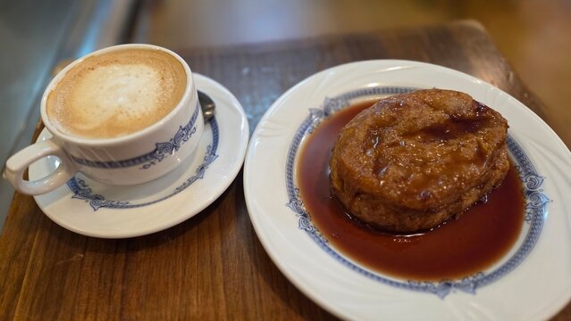 Delicious torrija dessert served with coffee in a cozy cafe setting. Traditional spanish dessert for Lent and Holy Week. French toast with wine