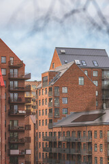 Evening view of modern brick apartment buildings and suspension bridge in Gothenburg.