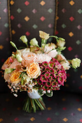 Beautiful modern bridal bouquet of colorful fresh flowers with silk ribbons. Classic wedding traditional accessory. Bride's  morning details.