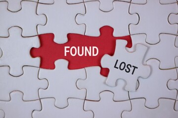 A jigsaw puzzle shows a red 'FOUND' piece adjacent to a white 'LOST' piece, symbolizing missing links, belonging, and the quest for balance in personal and professional life.