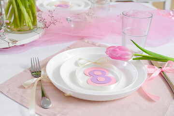 Beautiful table setting with tulip flower for International Women's Day celebration, closeup