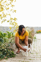 Woman holding happy baby goat in farm setting