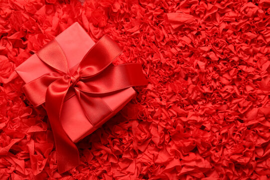 Gift box on red textured background. Valentine's Day celebration