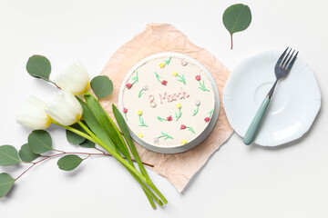 Sweet bento cake with beautiful tulips and leaves on white background. International Women's Day
