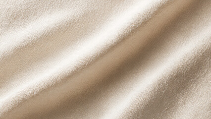 Fototapeta premium A close-up of a soft, textured, light beige fabric with gentle folds, highlighting its natural weave and subtle color.