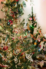 Artificial Christmas trees decorated with vintage and old glass beaded ornaments in retro style, selective focus