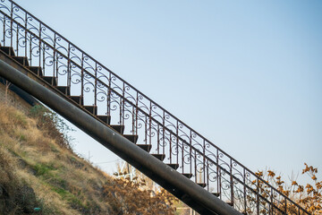 A set of iron stairs with a metal rail
