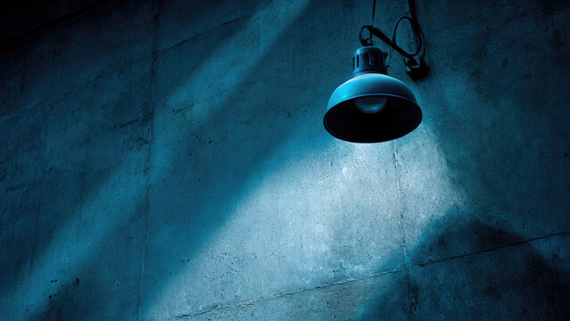 A vintage industrial lamp casts cool blue light on a textured concrete wall. Dramatic shadows emphasize the gritty surface, creating a mysterious mood. - Powered by Adobe