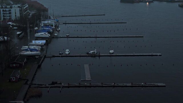 Serene maritime evening, Tranquil aerial shot capturing deserted docks and subdued city glow at dusk