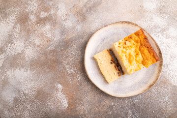 Сottage cheese Сasserole, Curd cake, with dried apricots and raisins on brown concrete, top view, copy space