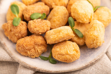 Fried crispy Chicken Nuggets with ketchup, microgreen on brown concrete. Diet, healthy eating. side view, selective focus