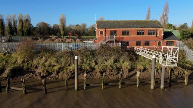 Aerial view of brick building on riverside, United Kingdom.
