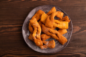 Crunchy biscuit Brushwood cookies on brown wooden, top view, flat lay, close up