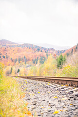 Railroad track leading into the distance. Track among autumn mountain landscapes
