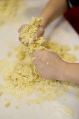 Teenagers cooking homemade pizza together in kitchen