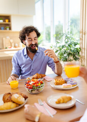 Couple enjoying breakfast in a bright kitchen