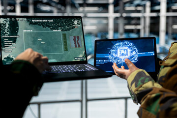 Close up of army experts in data center tracking missile trajectories using AI powered detection systems. Military units in server room identifying incoming threats with machine learning targeting