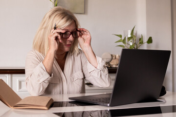 Mature woman working from home using laptop