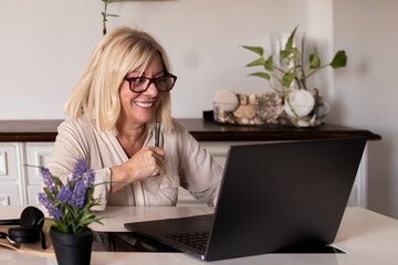 Senior woman smiling while working from home