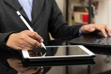 a right hand of a modern business man ready to design something on a white tablet at the left side of the screen