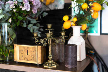 A beautifully arranged display features vintage objects like a candelabra, an antique clock, and lush floral arrangements. The setting exudes warmth and sophistication, ideal for family gatherings.