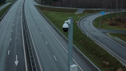 Elevated security installation keeps watch over deserted motorway during low evening illumination hours - Powered by Adobe