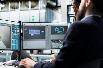 Diverse industrial employees team evaluates solar panel units for defects, ensuring the production process meets quality standards vital to the renewable energy industry success.