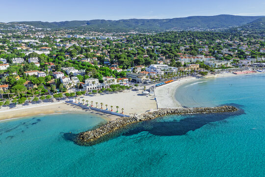 Waterfront of La Ciotat with coastal buildings and breakwaters, aerial view. Urban shoreline on the Mediterranean.