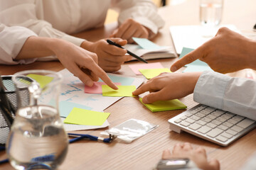 Business team with many sticky notes during meeting in office, closeup