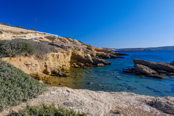 Coast of Ano Koufonisi with emerald water and yellow rocks