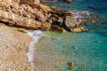 Coast of Ano Koufonisi with emerald water and yellow rocks