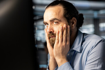 Data center cybersecurity worker scared by security breach. Worried IT staff member in data center panicking, trying to protect servers from hacker attack stealing sensitive information