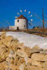 Traditional windmill against a blue sky at sunset in Koufonisia
