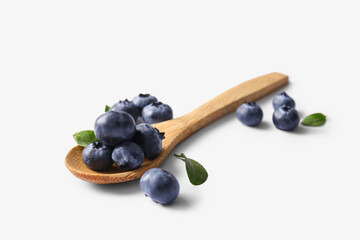 Wooden spoon with fresh ripe blueberry on white background, closeup