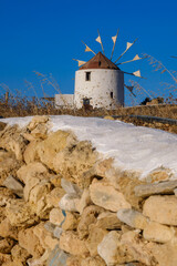 Traditional windmill against a blue sky at sunset in Koufonisia