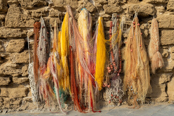 A display of colorful  fishnets against a wall