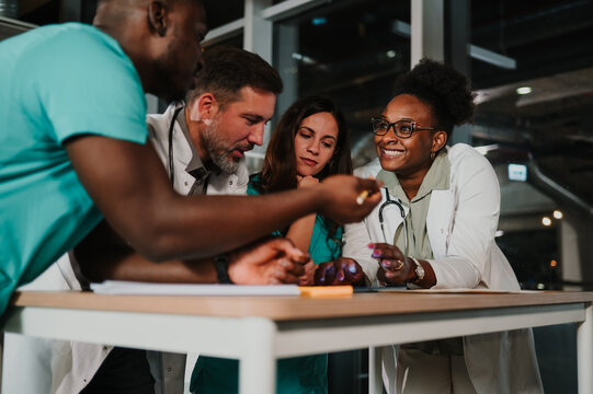 Healthcare team collaborating during hospital meeting at night