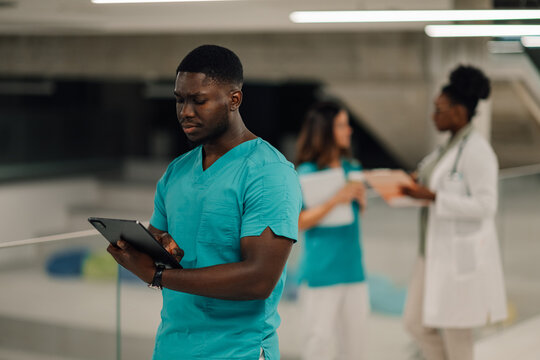 Young male doctor using tablet in hospital
