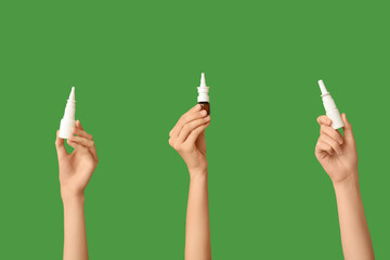 Female hands with different bottles of nasal spray on green background